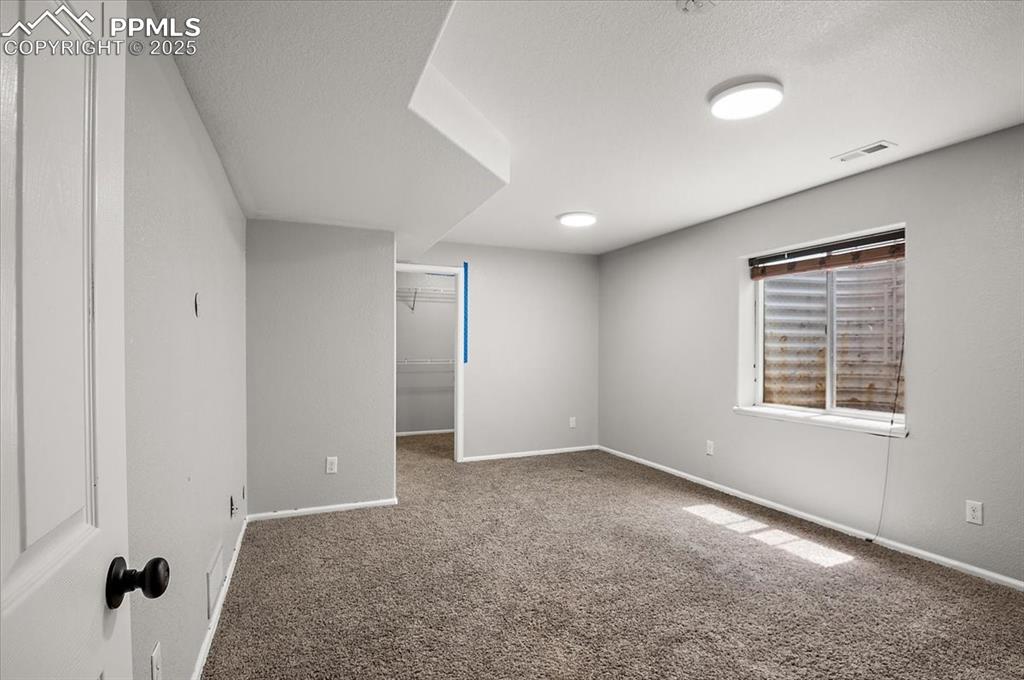 Image 14 of 35: Carpeted empty room featuring a textured ceiling