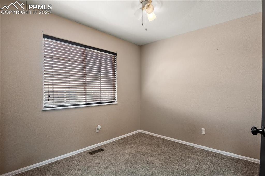 Image 16 of 35: Carpeted spare room featuring ceiling fan and baseboards