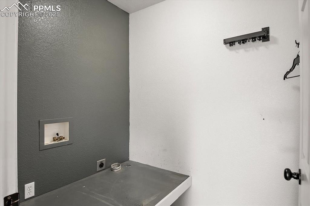 Image 22 of 35: Laundry room featuring washer hookup, a textured wall, and electric dryer h