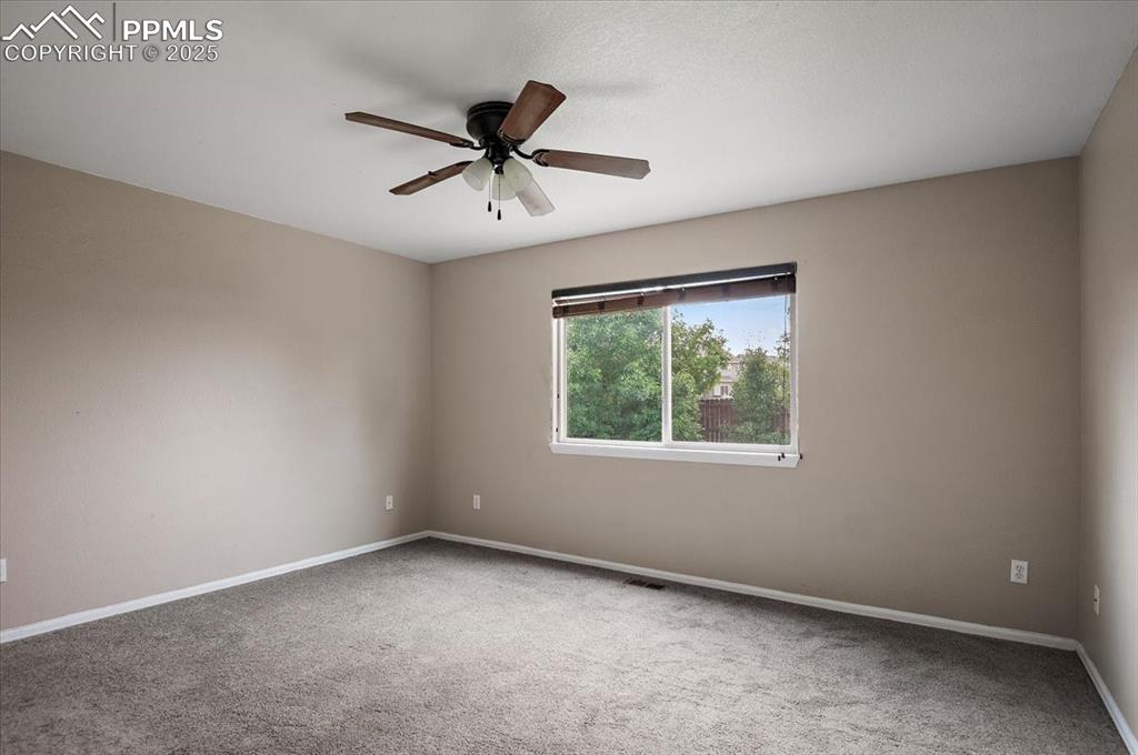 Image 26 of 35: Carpeted empty room with ceiling fan and baseboards