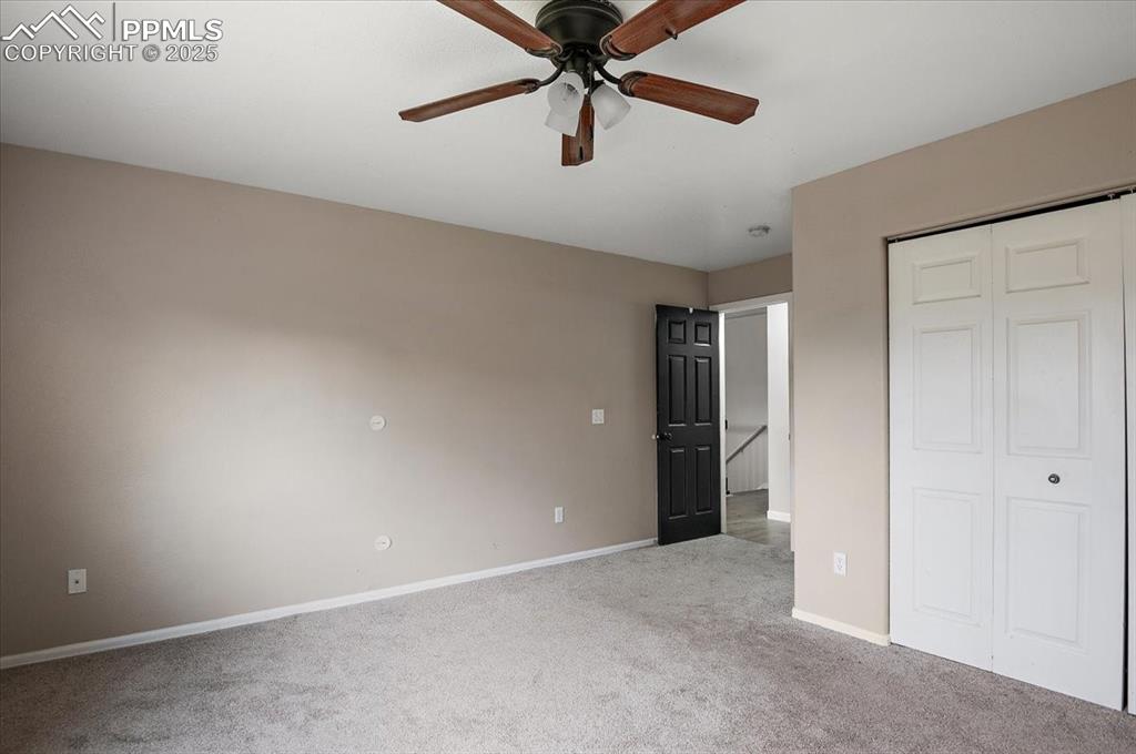 Image 27 of 35: Unfurnished bedroom featuring carpet, a closet, and ceiling fan