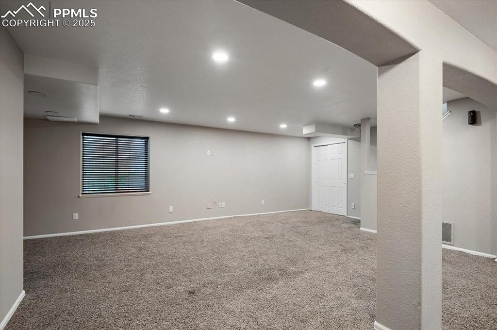 Image 29 of 35: Below grade area featuring recessed lighting and carpet flooring