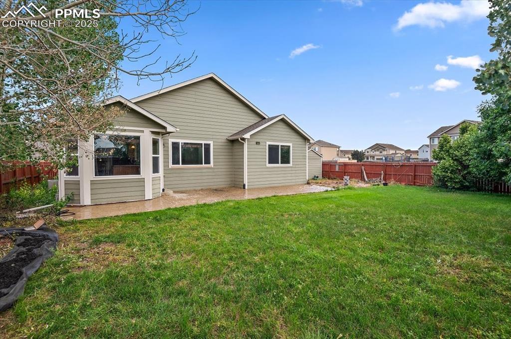 Image 4 of 35: Back of property featuring a patio
