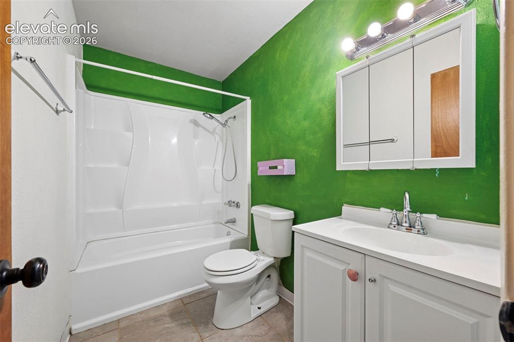 Image 14 of 29: Bathroom featuring a stand-up shower, white vanity with integrated sink, ch
