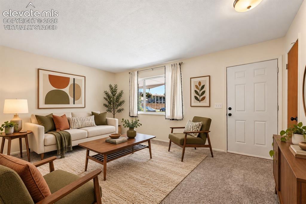 Image 2 of 28: virtually staged - Living room, cozy setting with new carpet.