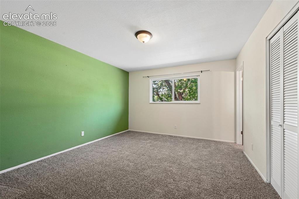 Image 25 of 29: Room featuring soft carpet flooring, a single window, a flush mount ceiling