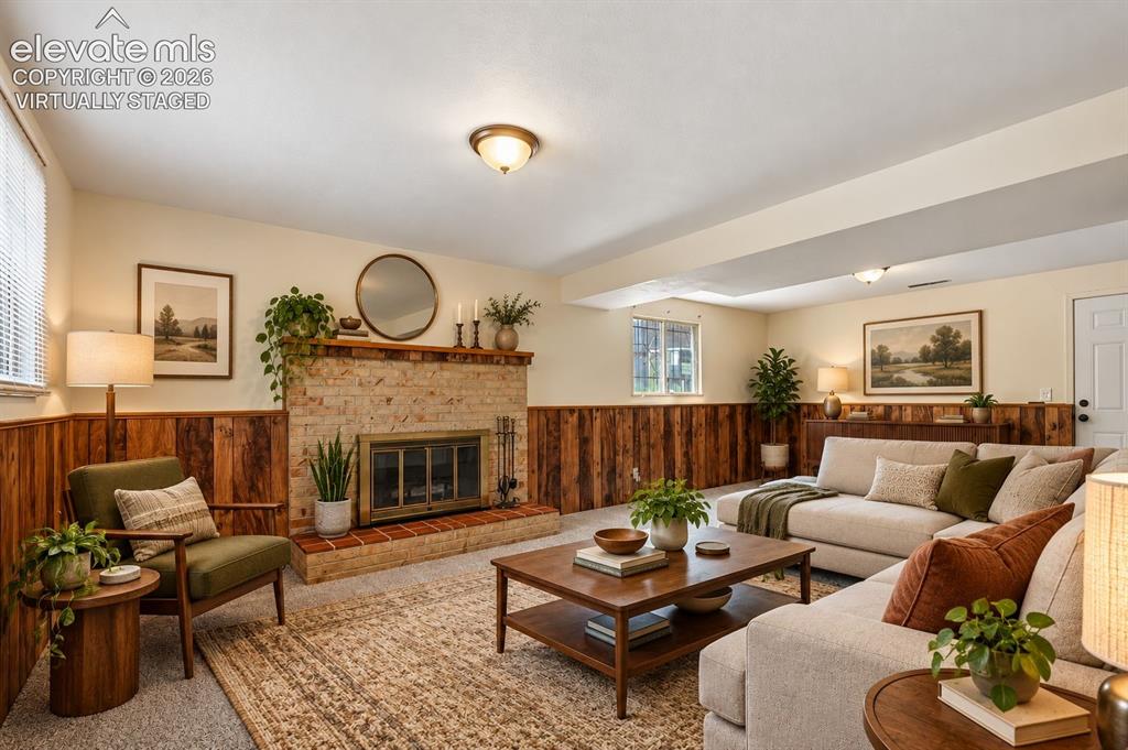 Image 3 of 28: virtually staged Family Room with woodburning fireplace.