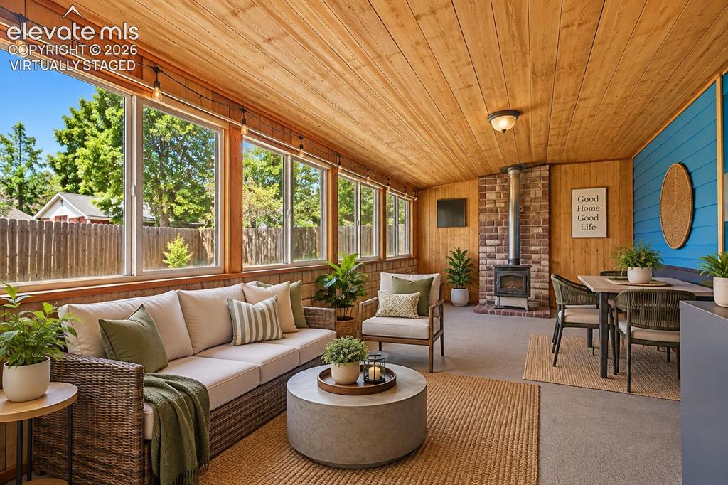 Image 4 of 28: virtually staged Large fully covered sun room perfect with tons of space.