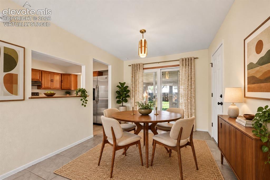 Image 5 of 28: virtually staged Tiled separate dining room.