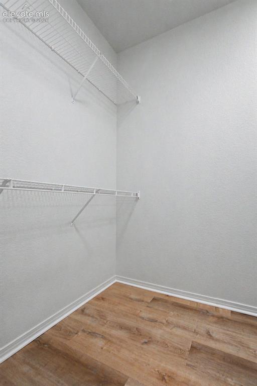 Image 11 of 23: Storage area featuring wood-finish flooring, white walls, and two levels of