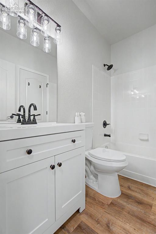 Image 12 of 23: Adjoining bathroom with a white vanity with dark hardware