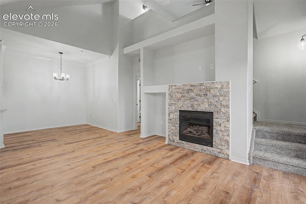 Image 13 of 23: Vaulted ceilings, stacked stone fireplace, ample natural light