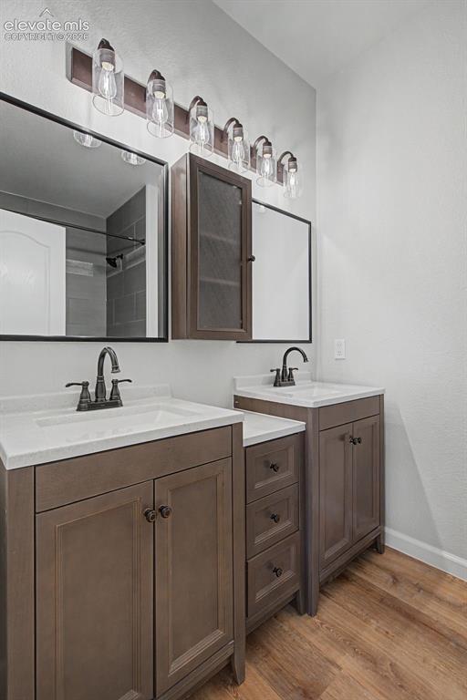 Image 20 of 23: Adjoining Primary Bathroom with new dual vanities and integrated sinks with