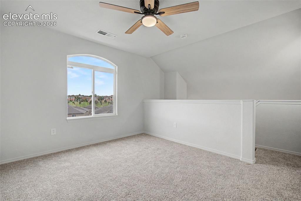 Image 23 of 23: New carpet and ceiling fan with light, and a half-wall railing