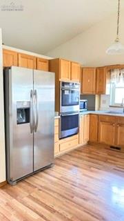 Image 41 of 50: Kitchen featuring brand new stainless refrigerator