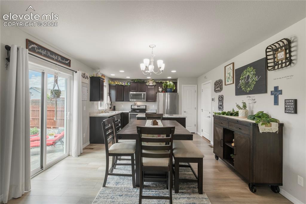 Image 10 of 38: Kitchen featuring dark wood-finish cabinetry, stainless steel appliances, a