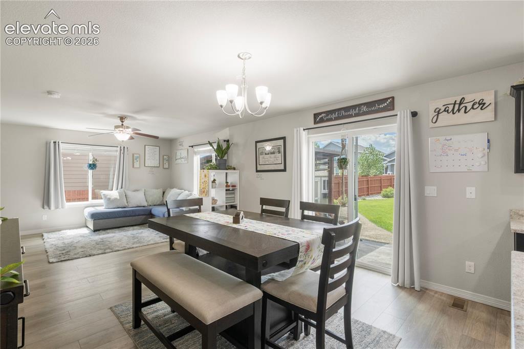 Image 12 of 38: Recessed lighting, wood-finish flooring, ceiling fan, sliding glass door, a