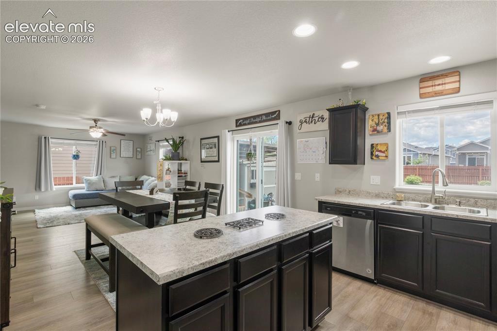 Image 15 of 38: Open-concept living space featuring wood-finish flooring, recessed lighting