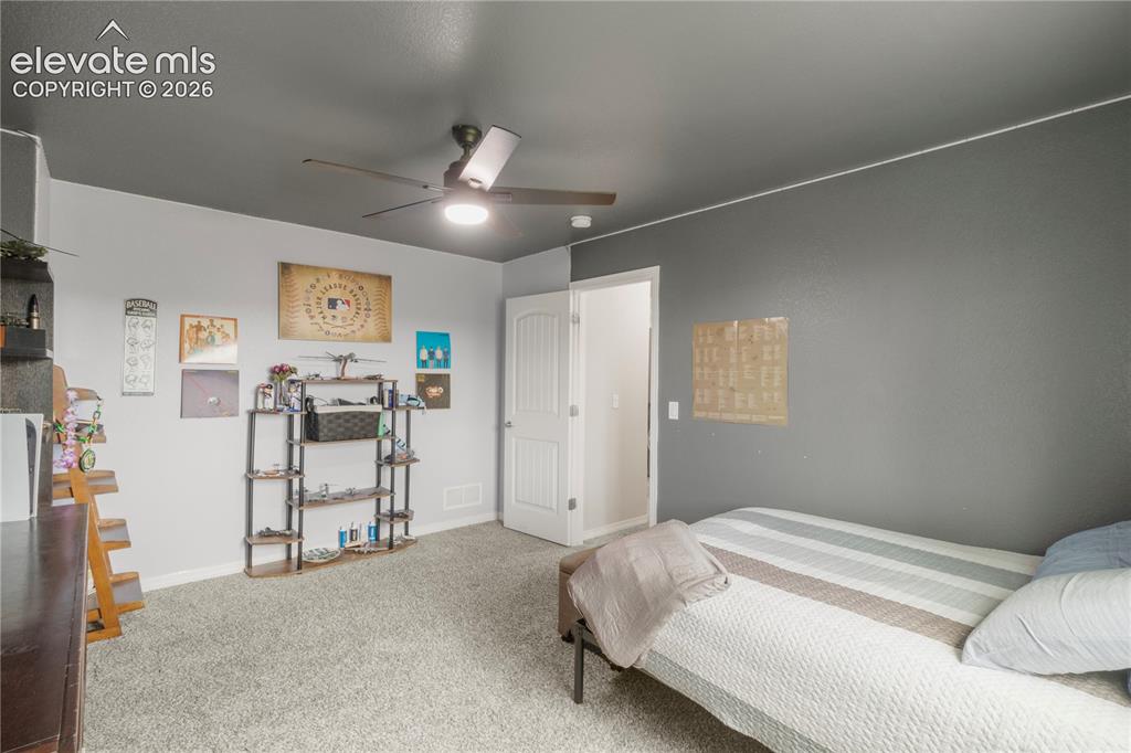 Image 26 of 38: Recessed lighting, ceiling fan, and light gray carpeting