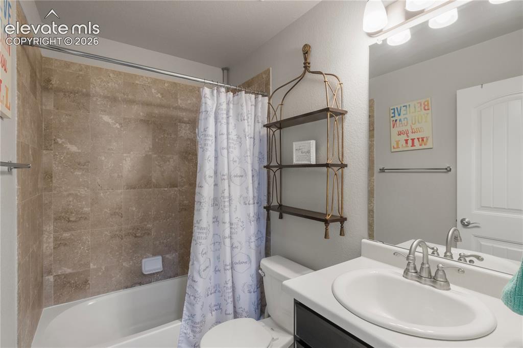 Image 27 of 38: White vanity with an integrated sink and chrome faucet