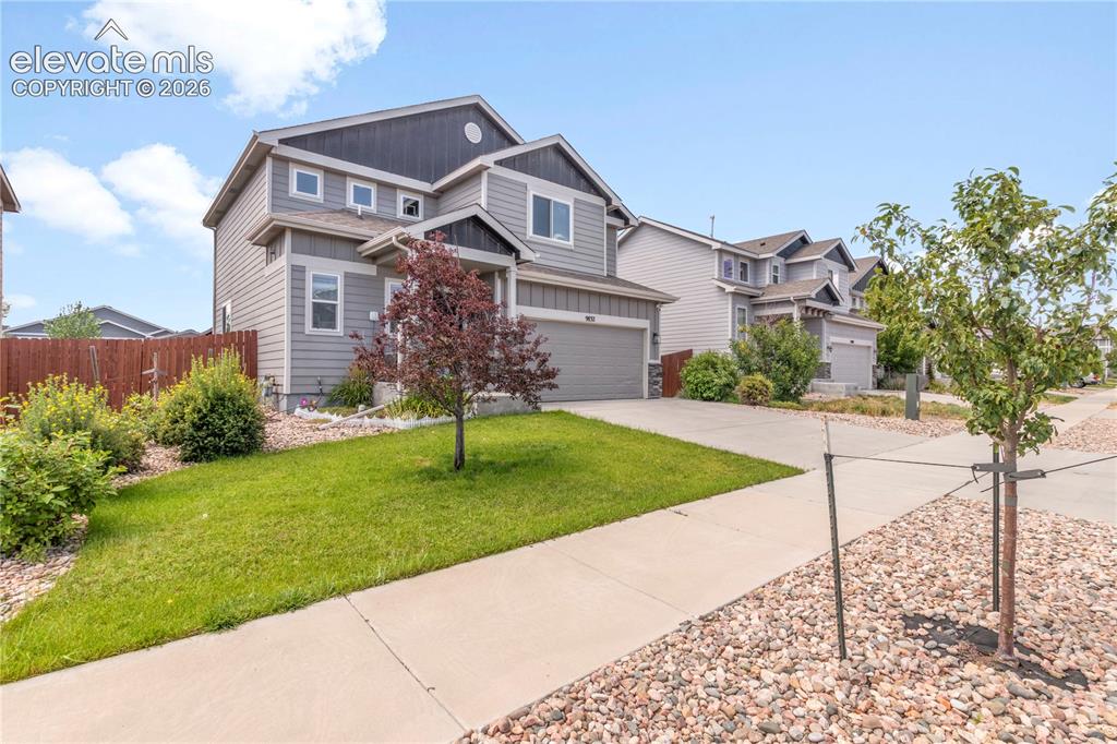 Image 3 of 38: Contemporary two-story exterior with gray siding, attached garage, concrete