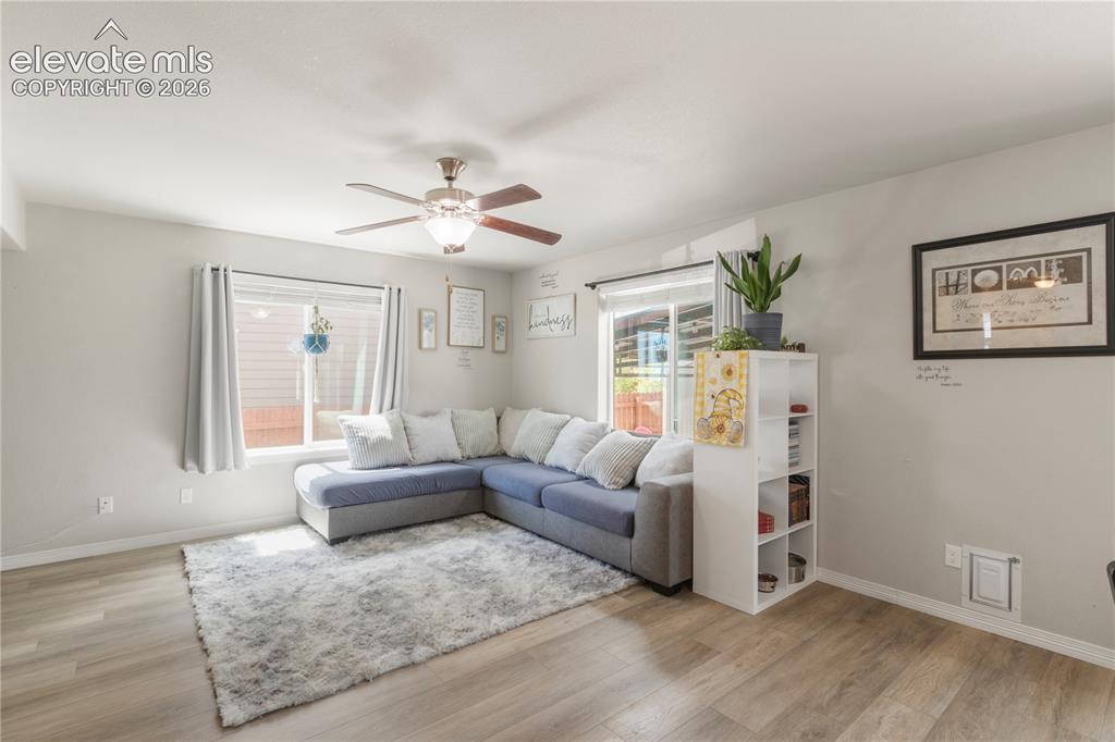 Image 7 of 38: Wood-finish flooring throughout, ceiling fan with integrated lighting, larg