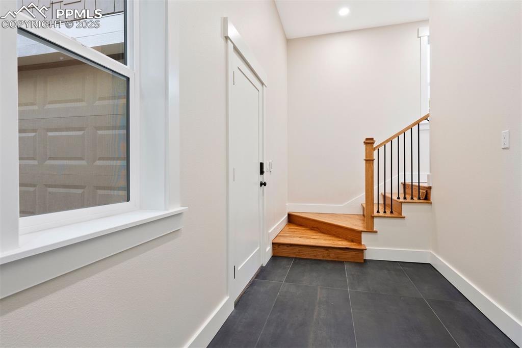 Image 24 of 39: The mud room off the attached garage has heated slate floors.