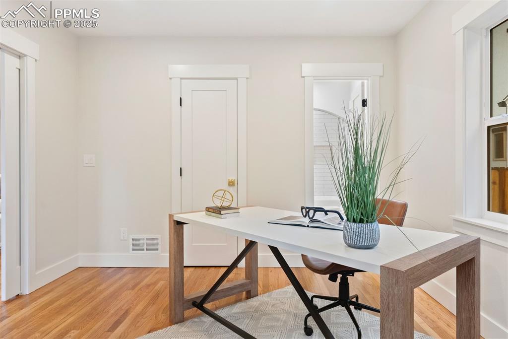 Image 4 of 39: Front main level bedroom, being used as
 an office.