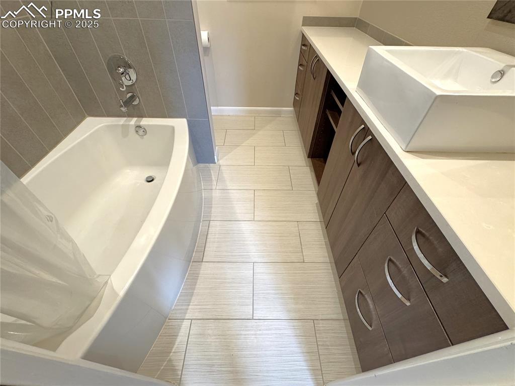 Image 21 of 48: Full bathroom with vanity and tile patterned floors