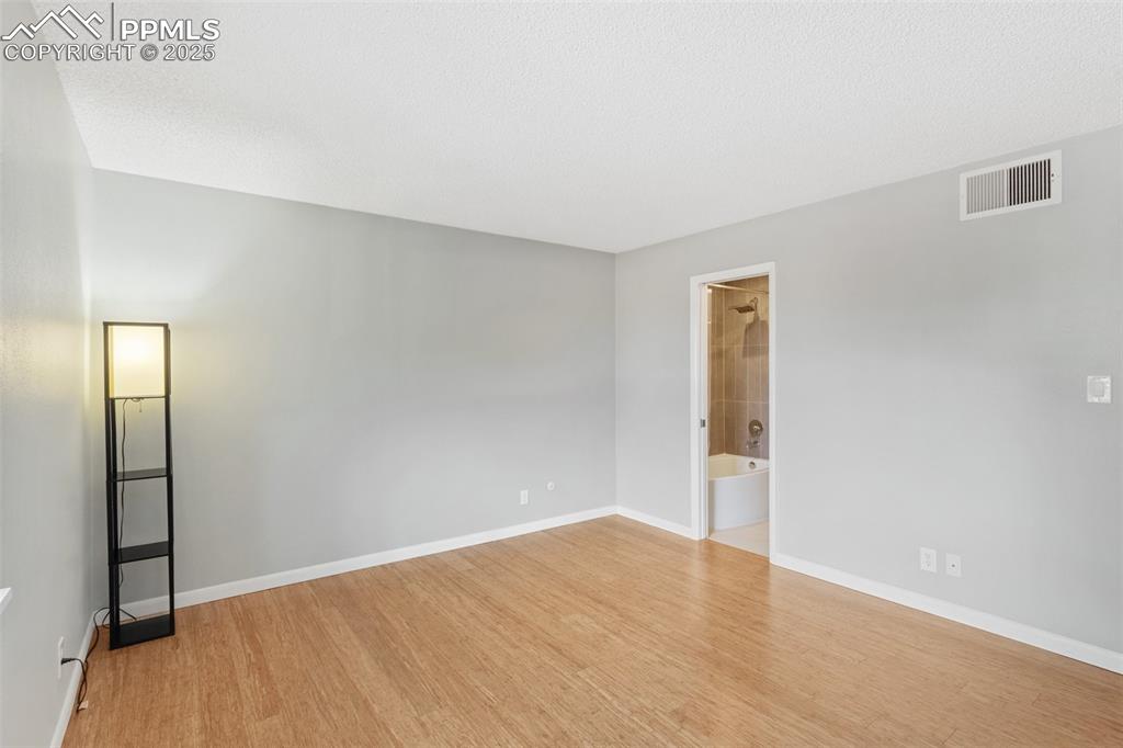Image 23 of 48: Master Bed with wood finished floors and baseboards