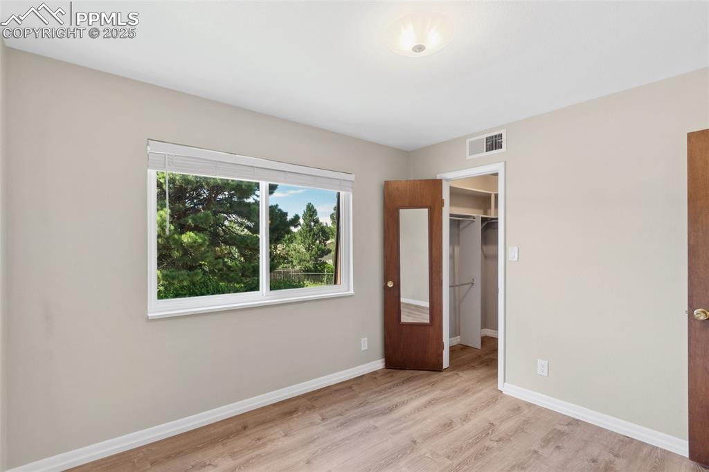 Image 30 of 48: 2nd Bedroom featuring light wood-type flooring and a spacious closet