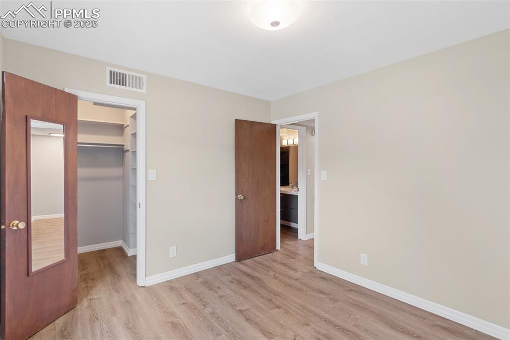 Image 31 of 48: 2nd Bedroom featuring light wood-style floors and a spacious closet
