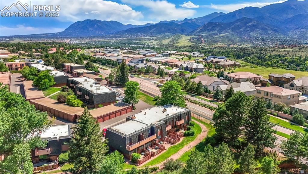 Image 4 of 48: Aerial perspective of suburban area featuring a mountainous background