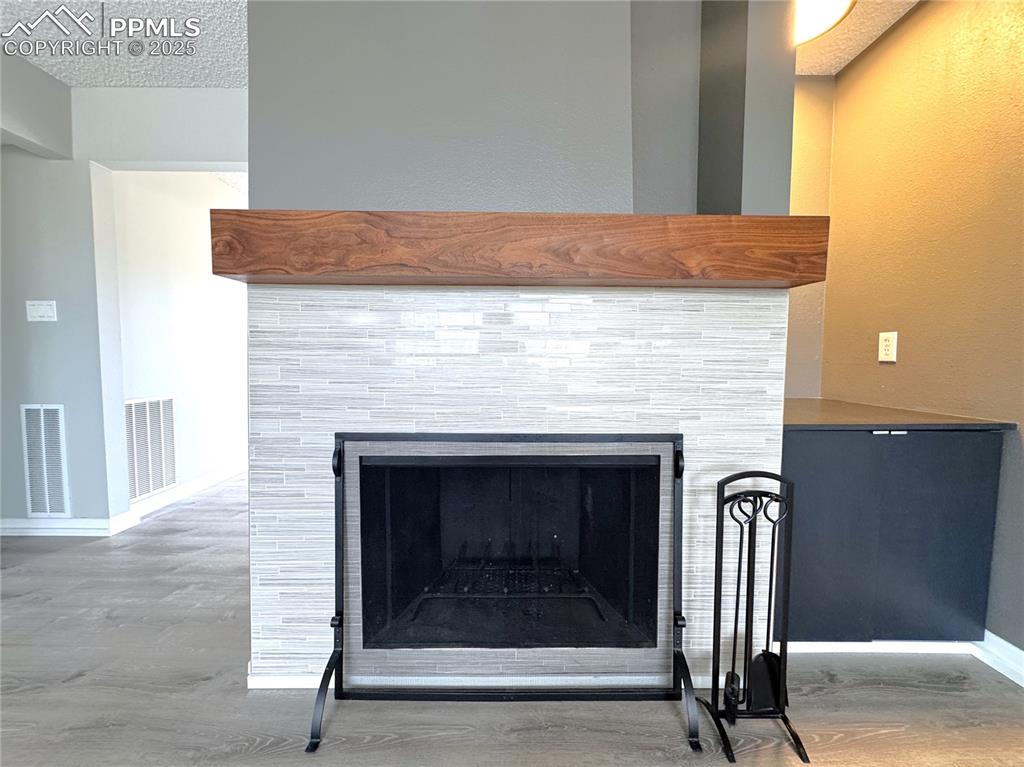 Image 41 of 48: Detailed view of a fireplace and wood finished floors