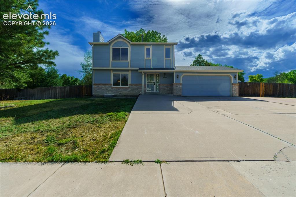 Image 1 of 33: Two-story residence featuring light blue siding with stone veneer accents