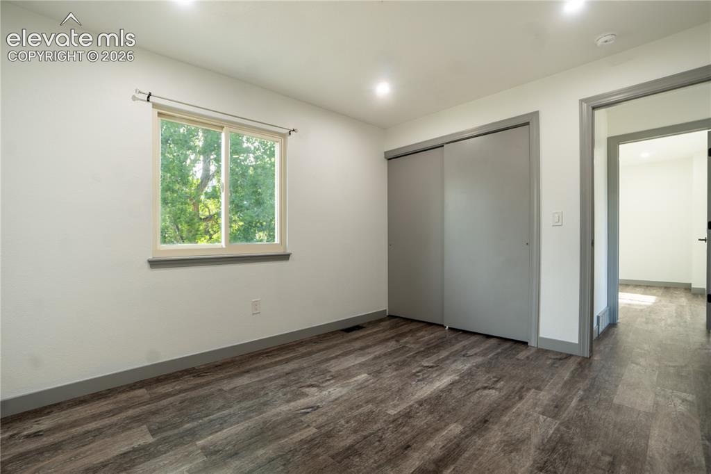 Image 17 of 33: Room featuring wood-finish flooring, recessed lighting, and a window with a