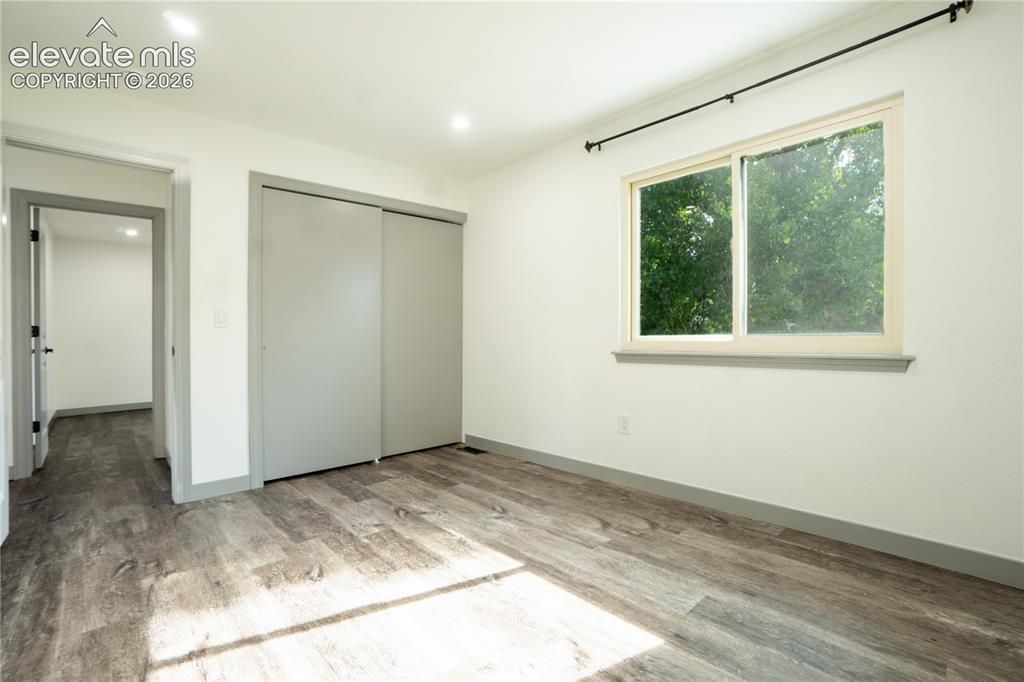 Image 20 of 33: Room featuring wood-finish flooring, recessed lighting, and a window with a