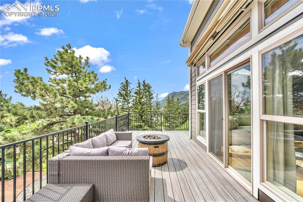 Image 2 of 29: Deck featuring an outdoor living space with a fire pit and a mountain view