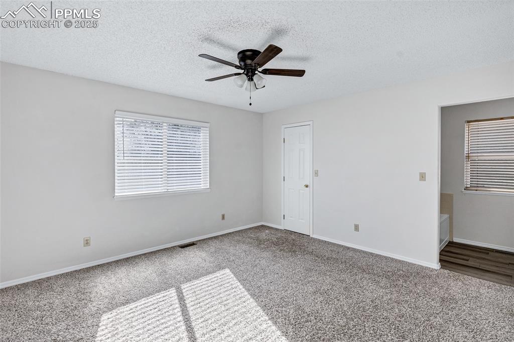 Image 14 of 25: Unfurnished bedroom featuring carpet flooring, a textured ceiling, and ceil
