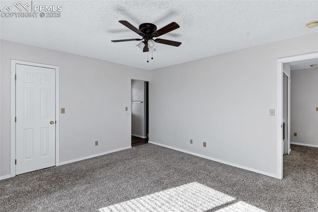Image 15 of 25: Unfurnished bedroom featuring a textured ceiling, carpet flooring, and ceil