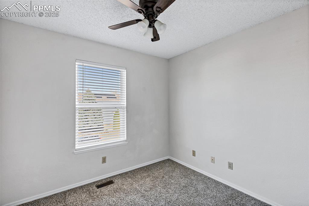 Image 19 of 25: Spare room with carpet flooring, a textured ceiling, and ceiling fan