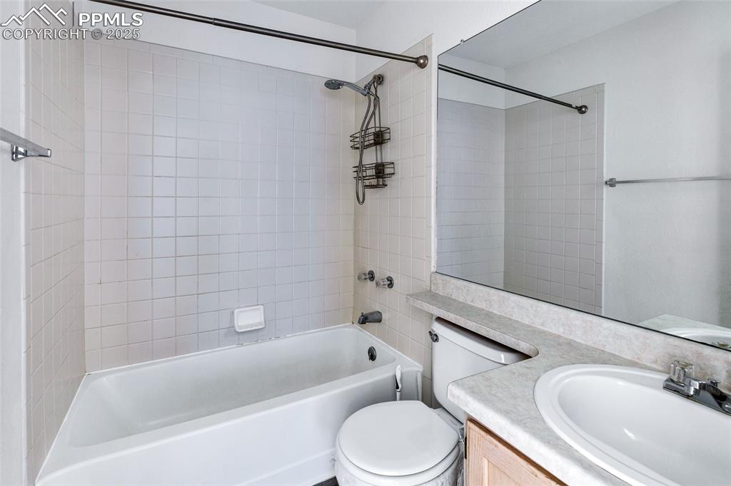 Image 20 of 25: Bathroom with vanity and  shower combination