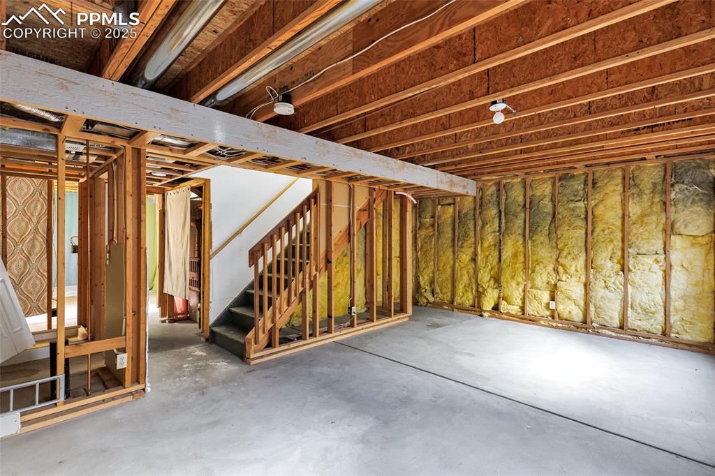 Image 21 of 25: Unfinished basement featuring stairs