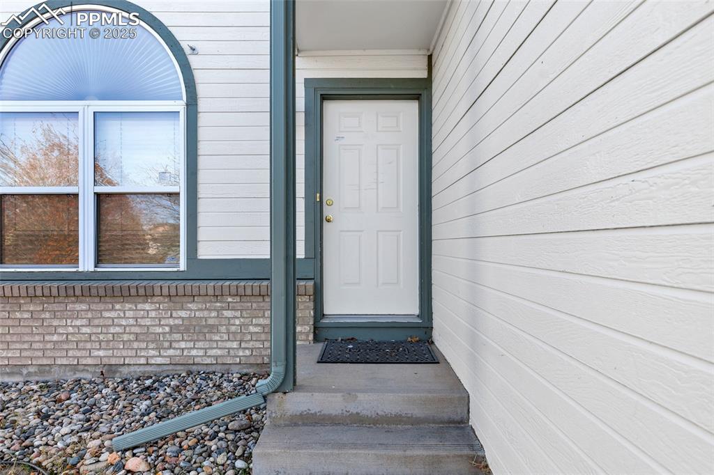 Image 4 of 25: View of exterior entry featuring brick siding