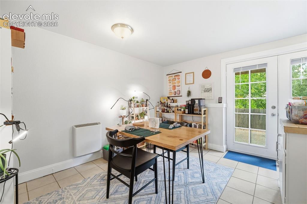 Image 24 of 46: Downstairs unit dining area, french doors to backyard