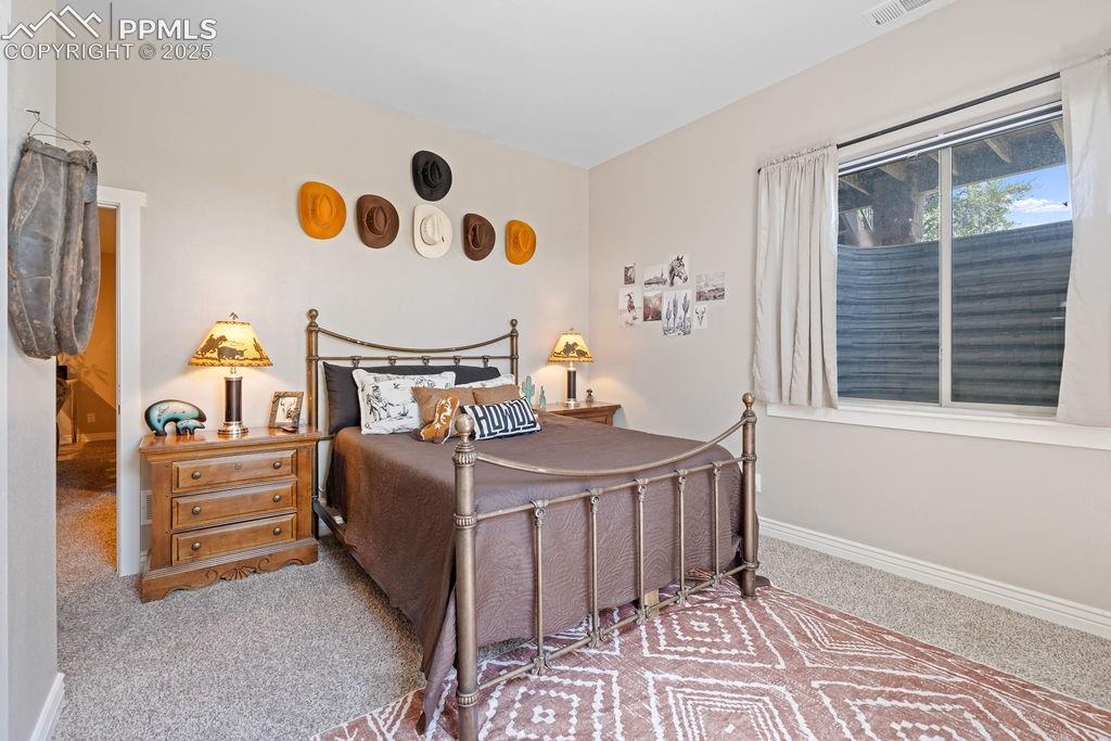 Image 17 of 50: Bedroom with carpet flooring and baseboards