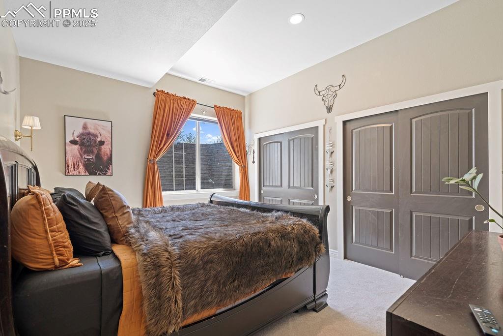 Image 21 of 50: Bedroom featuring light carpet and recessed lighting