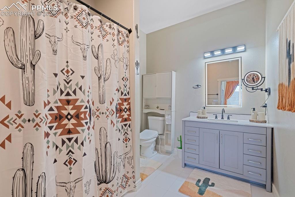 Image 21 of 50: Full bathroom featuring vanity, a shower with shower curtain, and light til