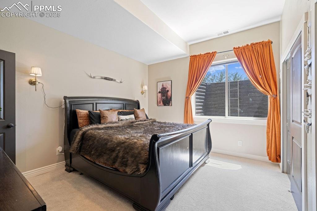 Image 24 of 50: Bedroom with light colored carpet and a closet