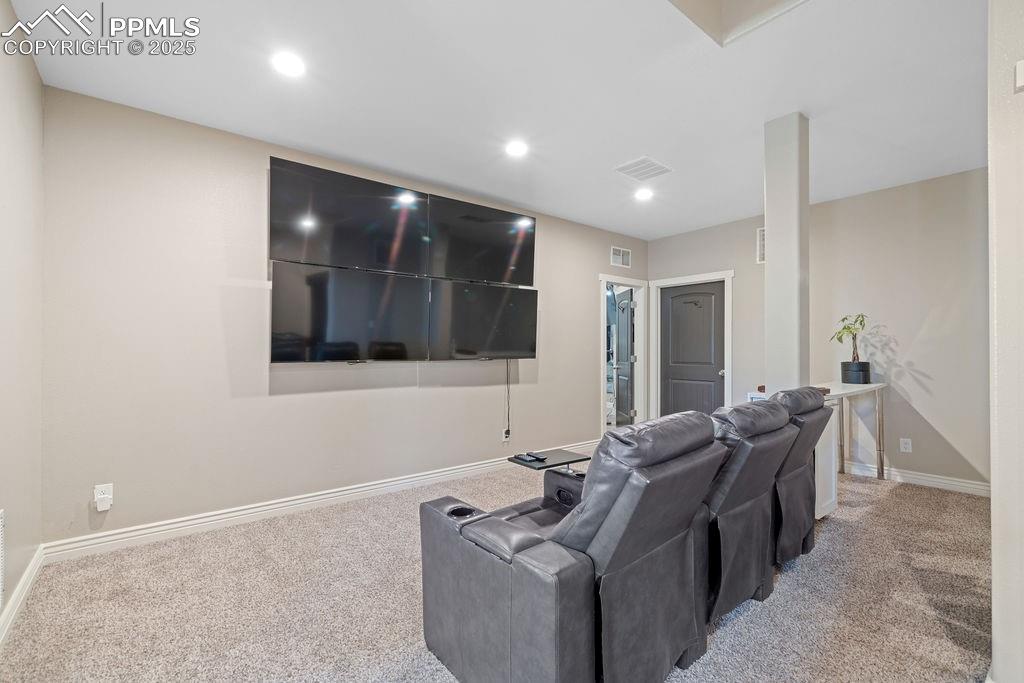 Image 29 of 50: Home theater room featuring carpet flooring and recessed lighting